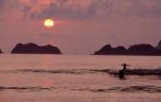 A surfer catches a ride near the island, which is a popular spot for surfing. JP/Tarko Sudiarno


