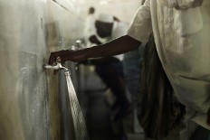 Muslim pilgrim performs Wudu, a ritual washing before prayers, just outside the Grand Mosque in the Muslim holy city of Mecca, Saudi Arabia, Thursday, Sept. 8, 2016. Muslim pilgrims have begun arriving at the holiest sites in Islam ahead of the annual hajj pilgrimage in Saudi Arabia, with some weeping with their hands outstretched for a fleeting touch of the Kaaba. The cube-shaped shrine, at the center of Mecca's Grand Mosque, is the site the world’s 1.6 billion Muslims pray toward five times a day. AP Photo/Nariman El-Mofty