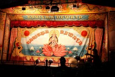 A man puts the finishing touches on stage decorations, using Balinese and Hindu ornaments. JP/ Aman Rochman