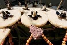 Ornaments made from sweet rice crackers and snacks are placed on the female-specific offerings. JP/Ganug Nugroho Adi