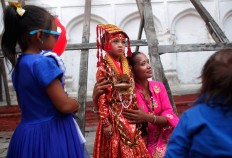 A Nepalese woman gets photographed with a young girl dressed as the Living Goddess Kumari while waiting for the Kumari puja to start at Hanuman Dhoka temple, in Kathmandu, Nepal, Wednesday, Sept. 14, 2016. AP Photo/Niranjan Shrestha