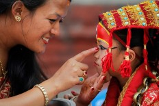 A Nepalese mother speaks with her daughter dressed as the living goddess Kumari as they wait for Kumari puja to start at Hanuman Dhoka temple, in Kathmandu, Nepal, Wednesday, Sept. 14, 2016. AP Photo/Niranjan Shrestha