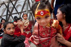 Young Nepalese girls wearing traditional costumes wait for the Kumari puja to start at Hanuman Dhoka temple, in Kathmandu, Nepal, Wednesday, Sept. 14, 2016. AP Photo/Niranjan Shrestha