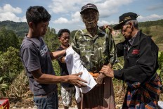 Relatives clean and care for the corpses of their departed loved ones. JP/ Agung Parameswara