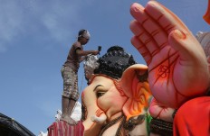 An Indian artist provides final touches to an idol of the elephant headed Hindu god Ganesha before it is carried off for worship to mark Ganesh Chaturthi festival, in Hyderabad, India, Monday, Sept. 5, 2016. The idol will be immersed in water bodies after worship at the end of the festival. AP Photo/Mahesh Kumar A.