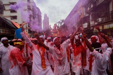 Hindu devotees participate in a procession towards the Arabian Sea where a giant idol of the elephant-headed god Ganesha will be immersed on the final day of the ten-day long Ganesha Chaturthi festival in Mumbai, India, Thursday, Sept. 15, 2016 . The last day of the 10-day celebration is the biggest day, with massive crowds singing and dancing as they carry their idols through the streets, to immerse them in the water, an act that symbolizes sending the god back to his mythical home in the snow-capped mountains taking all the worries and problems of his worshippers with him. AP Photo/Rafiq Maqbool