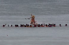 Devotees splash water as they prepare to immerse an idol of elephant-headed Hindu god Ganesha in the Arabian Sea after worship marking the end of the 10-day long Ganesh Chaturti festival in Mumbai, India, Thursday, Sept. 15, 2016. The act symbolizes sending the god back to his mythical home in the snow-capped mountains taking all the worries and problems of his worshippers with him. AP Photo/Rafiq Maqbool