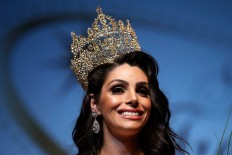 In this Sunday, Sept. 18, 2016 photo, the representative of Brazil, Rafaela Manfrini, smiles wearing the crown of the new Miss International Trans Star 2016, during a show celebrated in Barcelona, Spain. To be eligible to compete, contestants are not required to have undergone gender reassignment surgery, but must have the face and figure that comports with traditional notions of what constitutes ideal feminine beauty.  