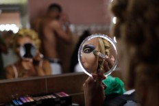 In this Sunday, Sept. 18, 2016 photo, Jey Jonnais, from Panama, applies make up ahead of the Miss Trans Star International 2016 show celebrated in Barcelona, Spain. 