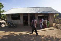 One of the two teachers arrives for the day. JP/ Sigit Pamungkas