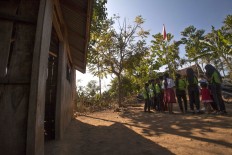 Students from the upper fourth through sixth grades take part in a study session in the front yard. JP/ Sigit Pamungkas