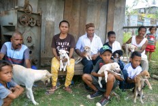 Residents wait for the arrival of medical officers to administer rabies vaccinations in Kampung Mbrata, Komodo district, Flores, on Aug. 31. On Flores and Lembata islands, rabies control and prevention are conducted through a vaccination program. JP/ Markus Makur