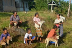 Residents wait to get their dogs vaccinated outside a meeting hall in Kampung Melo on Aug. 31. JP/ Markus Makur