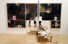 The legs of people are seen as they look towards part of an artwork by Helen Marten, one of the four artists shortlisted for the Turner Prize 2016, as it is displayed at the Tate Britain gallery in London, Monday, Sept. 26, 2016. The Turner Prize aims to promote public debate around new developments in contemporary British art. AP Photo/Kirsty Wigglesworth