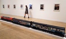 A woman walks past part of an artwork by Josephine Pryde, one of the four artists shortlisted for the Turner Prize 2016, as it is displayed at the Tate Britain gallery in London, Monday, Sept. 26, 2016. The Turner Prize aims to promote public debate around new developments in contemporary British art. AP Photo/Kirsty Wigglesworth