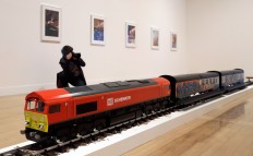 A photographer takes pictures of an artwork by Josephine Pryde, one of the four artists shortlisted for the Turner Prize 2016, as it is displayed at the Tate Britain gallery in London, Monday, Sept. 26, 2016. The Turner Prize aims to promote public debate around new developments in contemporary British art. AP Photo/Kirsty Wigglesworth