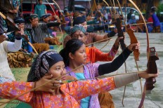 From their seated positions in neatly arranged rows, archers aim at the targets. JP/ Ganug Nugroho Adi