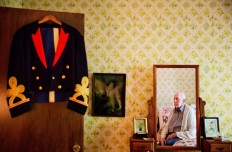 Frank Gleason, 96, a retired colonel with the Office of Strategic Services, looks at his old blue mess dress uniform hanging on a door as he sits in his home in Atlanta, Wednesday, Sept. 28, 2016. Legislation to recognize the contributions of a group of World War II spies is hung up in Congress. Some 75 years ago, the OSS carried out missions behind enemy lines in Nazi Germany and the Pacific theatre. The organization disbanded at the end of the war, but served as a forerunner to the CIA. AP Photo/David Goldman