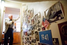 Memorabilia decorates a wall in the home of Frank Gleason, 96, rear, a retired colonel with the Office of Strategic Services, in Atlanta, Wednesday, Sept. 28, 2016. Legislation to recognize the contributions of a group of World War II spies is hung up in Congress. Some 75 years ago, the OSS carried out missions behind enemy lines in Nazi Germany and the Pacific theatre. Gleason's group was tasked with halting the Japanese advance into China. Gleason and his comrades did this by detonating bridges, railroad 
tracks and anything else. 'We just blew stuff up left and right,' said Gleason. AP Photo/David Goldman
