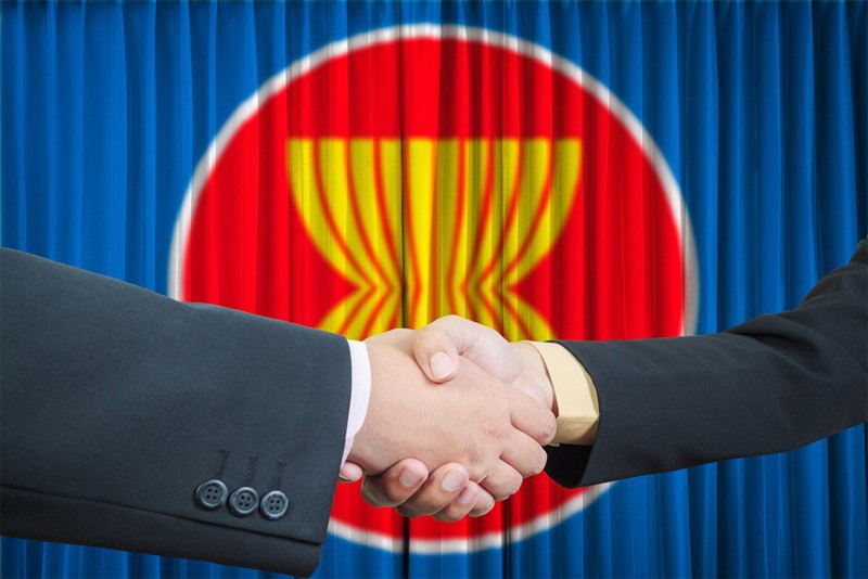Illustration of ASEAN cooperation against a backdrop bearing the ASEAN logo