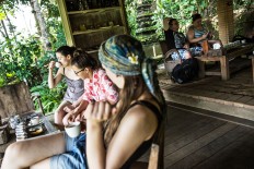 Tourists enjoy the beautiful scenery of coffee trees at the Bali Pulina agrotourism center in Tegalalang, Bali. JP/Agung Parameswara
