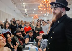 In this picture taken on Sunday, Oct. 16, 2016, a man smiles after having his beard evaluated by a jury during the National Competition for Beards and Mustaches which took place along with the International Tattoo Convention Bucharest 2016 in Bucharest, Romania. AP Photo/Vadim Ghirda