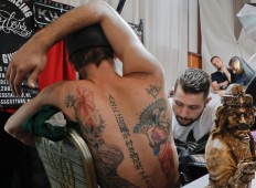 In this picture taken on Sunday, Oct. 16, 2016, a man gets a tattoo during the International Tattoo Convention Bucharest 2016 in Bucharest, Romania. More than 100 tattoo and piercing artists brought their skills and art to a three-day convention in the Romanian capital. AP Photo/Vadim Ghirda