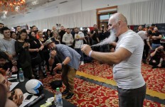 In this picture taken on Sunday, Oct. 16, 2016, a man shows off his mustache to a jury, claiming he has not trimmed it since 1979,  during the National Competition for Beards and Mustaches which took place along with the International Tattoo Convention Bucharest 2016 in Bucharest, Romania. More than 100 tattoo and piercing artists brought their skills and art to a three-day convention in the Romanian capital, while men showed off their facial hair in a contest. AP Photo/Vadim Ghirda