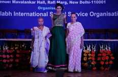 Indian Hindu widows walk with a model, center, during a fashion show in New Delhi, India, Saturday, Oct. 15, 2016. In most of India, millions of Hindu widows are expected to live out their days in quiet worship, dressed only in white. The widows are now breaking age-old traditions of staying aloof by actively participating in Hindu festivals like Holi and Diwali. They went a step further on Saturday, participating in a fashion show. AP Photo/Altaf Qadri