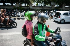 Yayuk takes motorcycle taxis and public transportation to get around. JP/ Anggara Mahendra