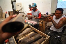 Craftsmen test a bamboo speaker ordered by a European buyer. JP/Aditya Sagita