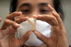 An artisan checks part of an Arabic puzzle at the workshop in September. JP/Aditya Sagita