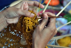 Solo Rajuter crochet community members, who are mostly housewives, demonstrate their skills by crocheting an umbrella.JP / Kus Hendratmo