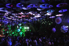 Visitors enjoy an umbrella display lit up by colored lights during the 2016 Indonesian
Umbrella Festival at Balekambang Park, Surakarta, in the evening. JP / Kus Hendratmo