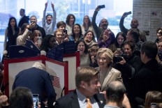 Democratic presidential candidate Hillary Clinton, accompanied by her husband, former President Bill Clinton, left, smiles as she votes at Douglas G. Grafflin School in Chappaqua, N.Y., Tuesday, Nov. 8, 2016. At far left is senior aide Huma Abedin. AP Photo/Andrew Harnik