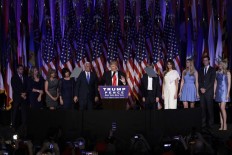 President-elect Donald Trump gives his acceptance speech during his election night rally as he is surrounded by his family and Vice-President-elect Mike Pence and his family, Wednesday, Nov. 9, 2016, in New York. AP Photo/John Locher
