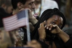 A woman weeps as election results are reported during Democratic presidential nominee Hillary Clinton's election night rally in the Jacob Javits Center glass enclosed lobby in New York, Tuesday, Nov. 8, 2016. AP Photo/Frank Franklin II