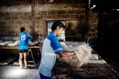 The noodles are sifted for the steaming process. JP/ Agung Parameswara
