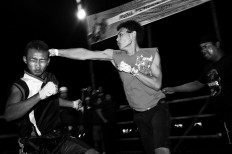 Participants of the Pencak Dor competition are allowed to use any martial art style [pencak silat, traditional martial arts, karate, boxing, wrestling] while fighting in a bamboo ring with tikar [woven mat] in  Kauman village, Blitar, East Java, on Oct. 12.  JP/ Aman Rochman
