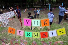 Boys compete in a stilt race during the event run by Sanata Dharma University in Yogyakarta to encourage experiential play.  JP/ Aditya Sagita
