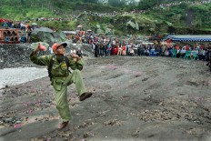 A local security officer does a spontaneous dance as part of the activities.  JP/ Tarko Sudiarno