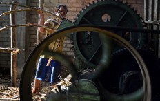 Supardi, 38, crushes the sugarcane to get the juice to make ondrongan brown sugar, which will be used to make seasonings in Genengan village in Malang, East Java. JP/ Aman Rochman