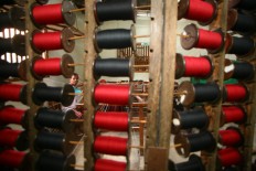 A man does the warping process and arranges the yarn according to its colors to weave them into lurik motifs. JP/Aditya Sagita