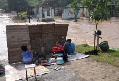 Several Kampung Sewu residents take shelter on higher ground in the river's embankment. JP/ Ganug Nugroho Adi