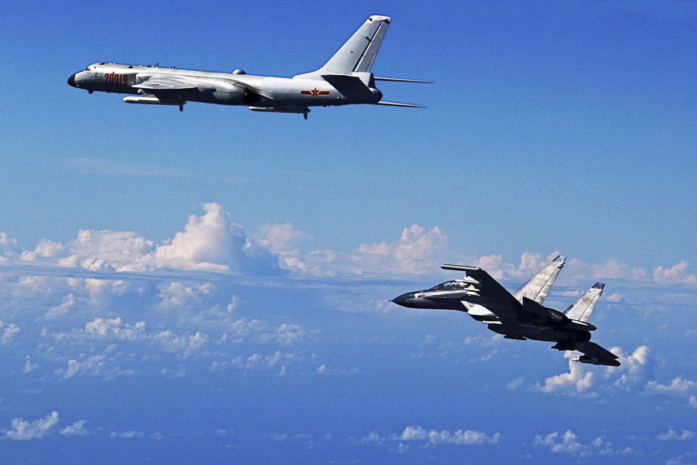 Growing tensions -- In this Sept. 25, 2016 file photo released by Xinhua News Agency, Chinese People's Liberation Army Air Force Su-30 fighter, right, flies along with a H-6K bomber as they take part in a drill near the East China Sea. China patrolled the waters of a series of hotly contested islands on Sunday a day after staging a flyover of two strategically important waterways near Taiwan and Japan. 