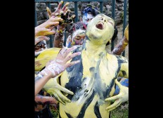 In Trance: A man, his body smeared in paint, enjoys the music while surrounded by others. JP/ Magnus Hendratmo