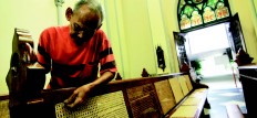 One by one: Samin, 69, patiently fixes a rattan benchin the Jakarta Cathedral in Central Jakarta. JP/ Donny Fernando