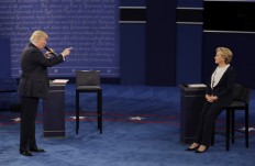 Republican presidential nominee Donald Trump speaks to Democratic presidential nominee Hillary Clinton during the second presidential debate at Washington University in St. Louis, on Oct. 9, 2016. 
