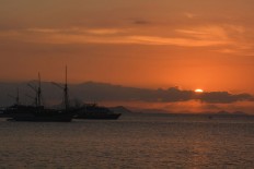 A fishing boat sails by during sunset at Labuhan Bajo, East Nusa Tenggara, on Saturday. JP/ Markus Makur
