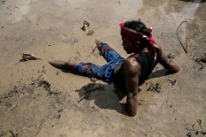A participant rests during a buffalo race in Kaliakah village in Jembrana. JP/ Agung Parameswara